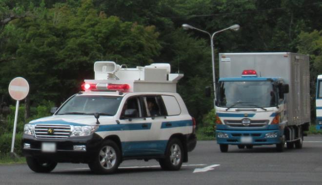 警察車両に乗る２名の警察官の写真